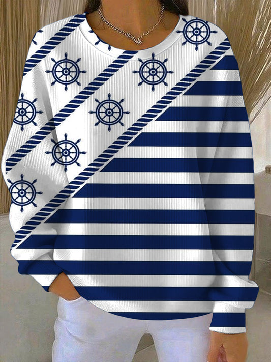 Damska bluza w kolorze białym i niebieskim w paski w stylu morskim z wzorami kół okrętowych